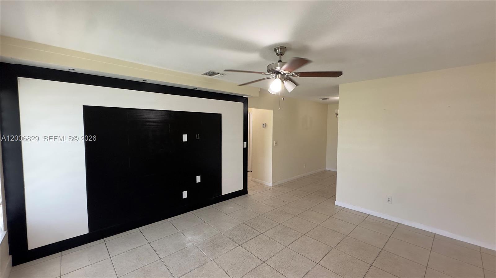 3733 Kirk Road Lake Worth, FL 33461 - Photo 3 of 24 a view of a livingroom with a chandelier fan and a bathroom