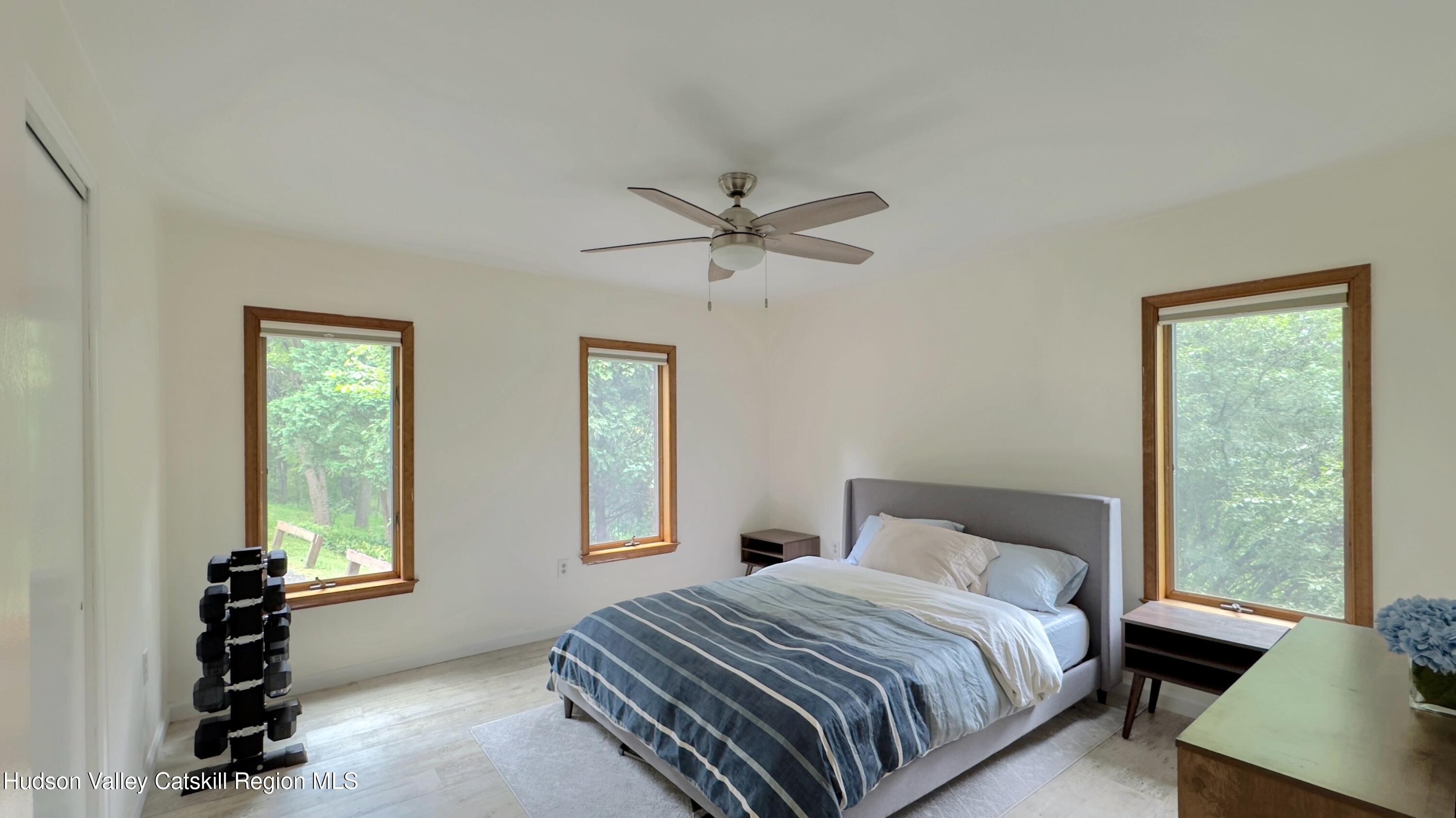 3223 Sleepy Hollow Road Athens, NY 12015 - Photo 45 of 55 a bedroom with a bed a window and a chandelier