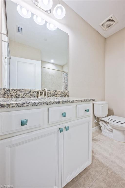 9374 Pocida Court, Unit 102 Naples, FL 34119 - Photo 14 of 21 a utility room with cabinets washer and dryer