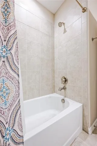 a bathroom with a bathtub and shower