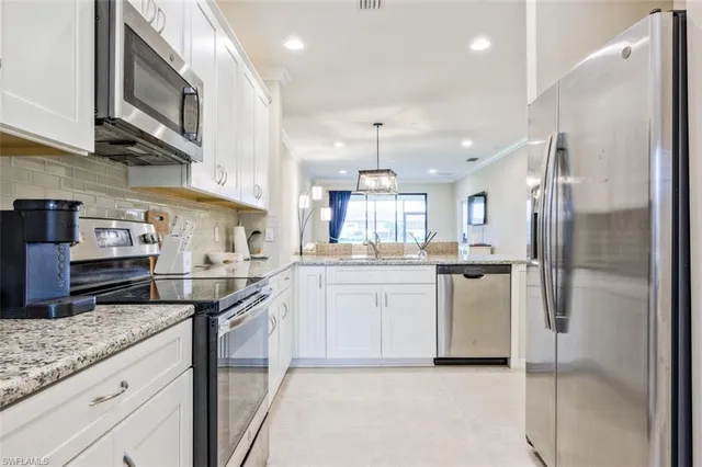 a kitchen with cabinets and stainless steel appliances