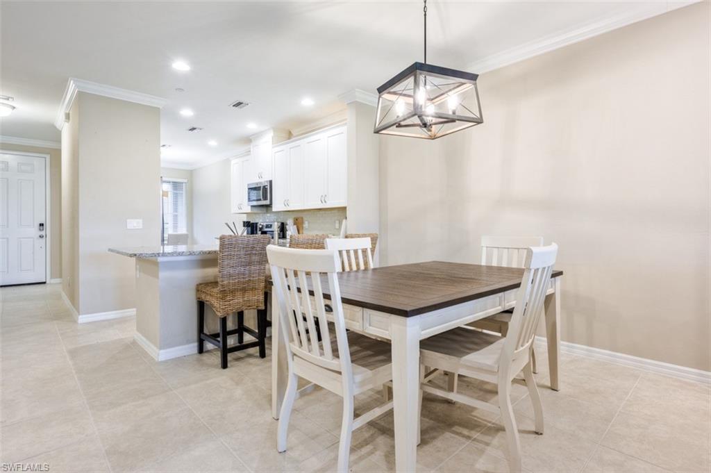 9374 Pocida Court, Unit 102 Naples, FL 34119 - Photo 7 of 21 a view of a dining room with furniture