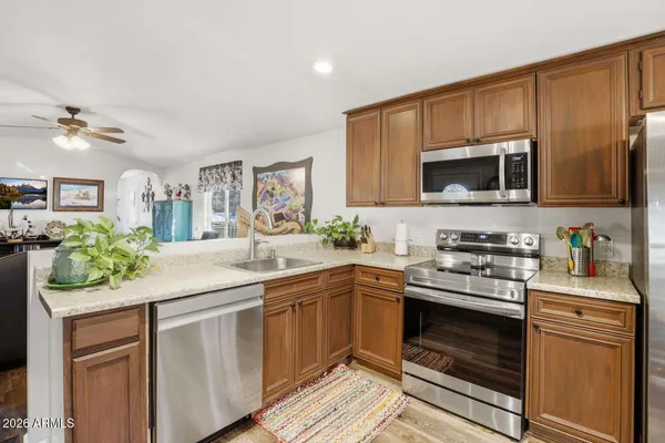 a kitchen with a sink stove and microwave
