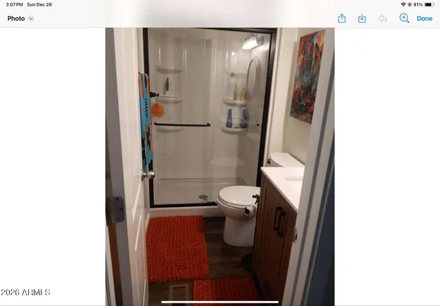 a bathroom with a toilet and a shower