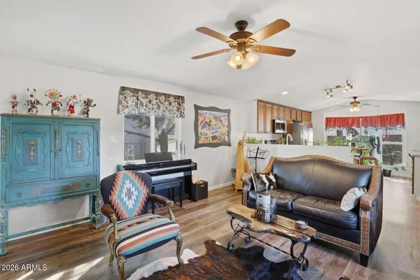 a living room with furniture and kitchen view