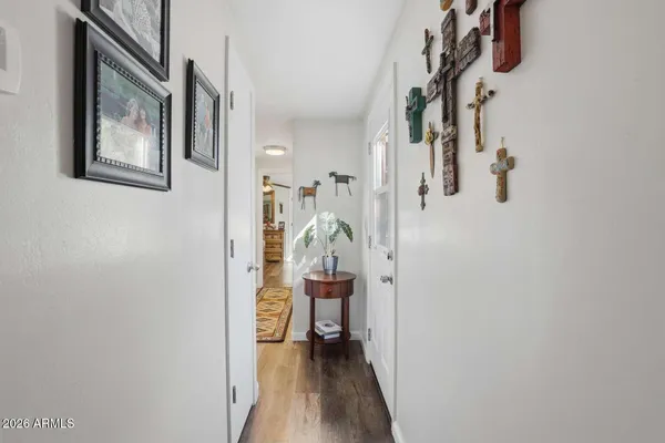 a view of a hallway with wooden floor and entryway