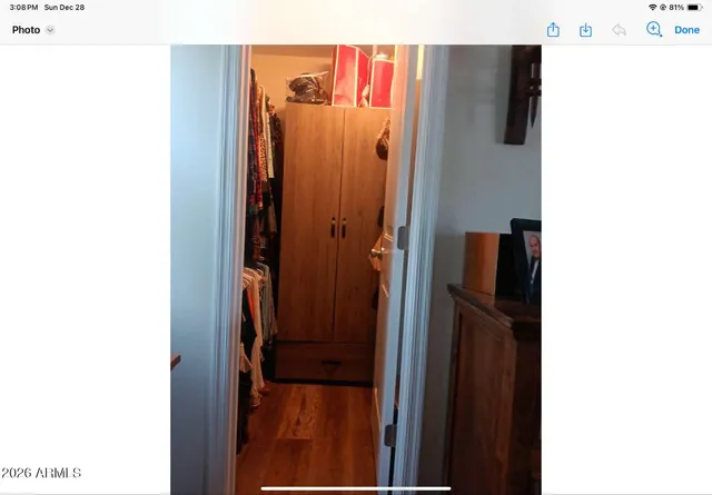 a view of a hallway with a refrigerator and a table