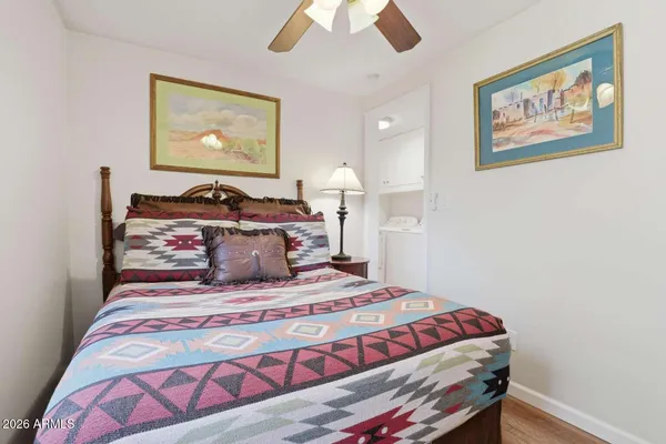 a bedroom with a bed and painting on the wall