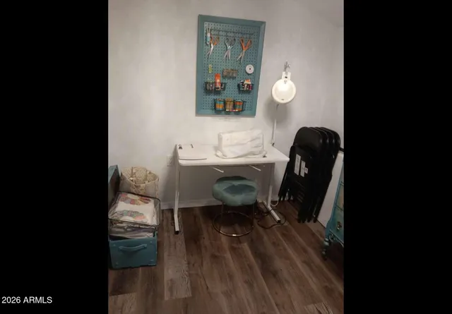 a view of a workspace with furniture and wooden floor