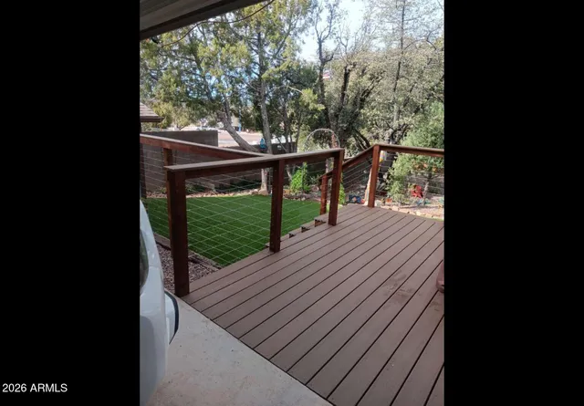 a view of a balcony with wooden floor