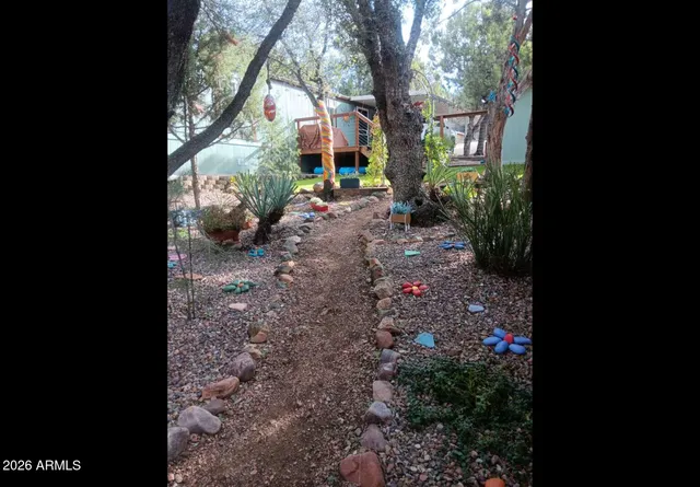 a view of a house with a yard and garden