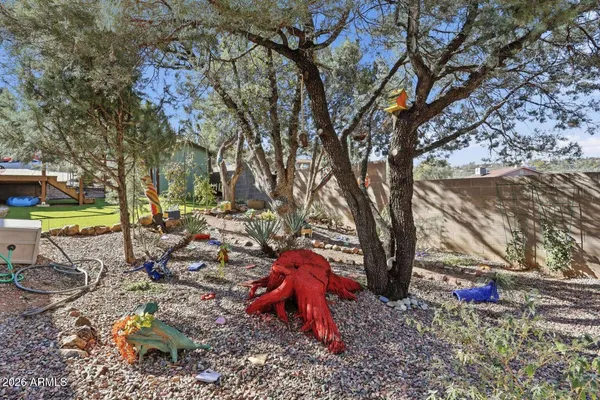 a backyard of a house with barbeque oven table and chairs