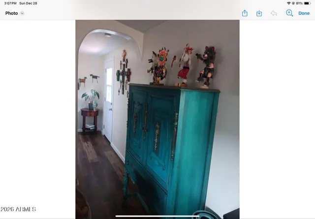 a view of a hallway with paintings on the wall