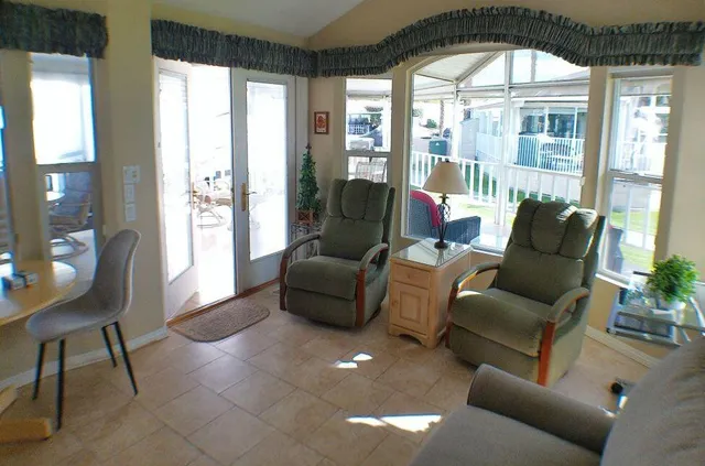a view of a livingroom with furniture and a flat screen tv