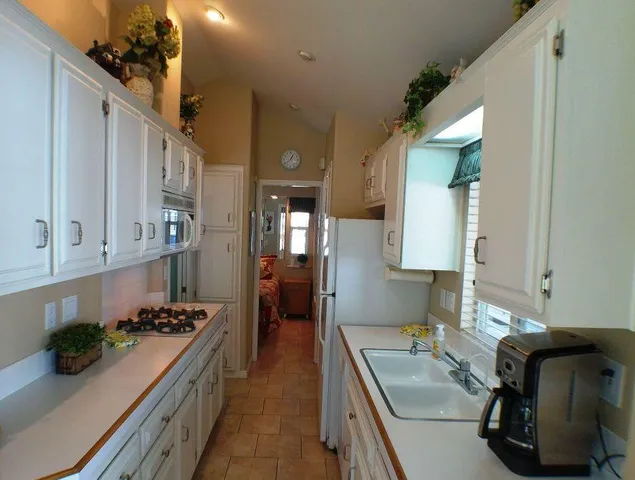 a kitchen with a sink and a stove top oven