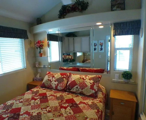 a bedroom with a bed and a painting on the wall