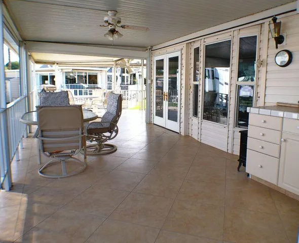 a living room with furniture cabinets and a ceiling fan