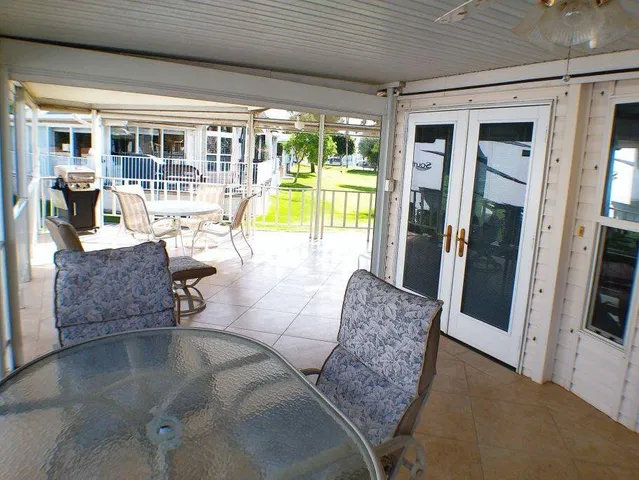 a spacious bathroom with a granite countertop sink a mirror and a shower