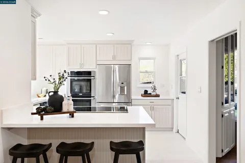 a view of center kitchen island a sink a table and chairs