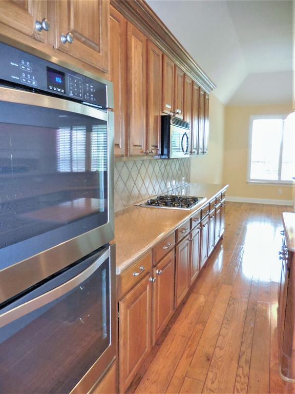 4012 Appleton Lane Flower Mound, TX 75022 - Photo 12 of 28 a view of a kitchen counter space and wooden floor