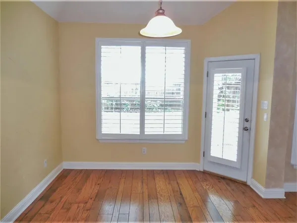 an empty room with chandelier fan