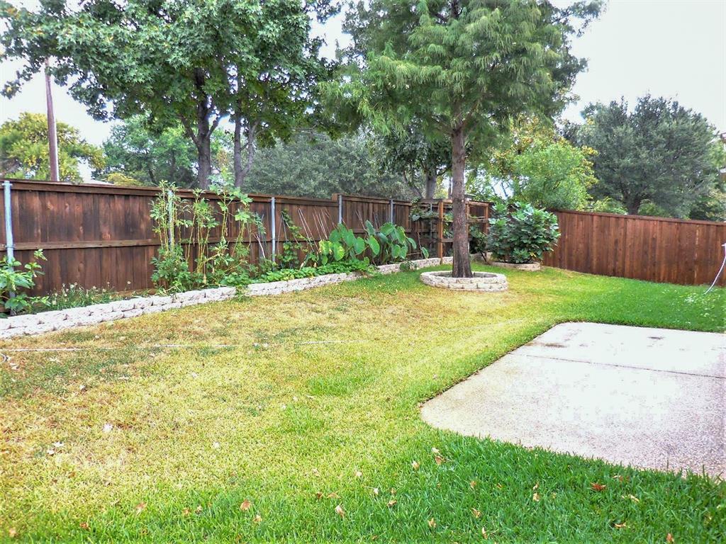 4012 Appleton Lane Flower Mound, TX 75022 - Photo 25 of 28 a view of a backyard with table and chairs and wooden fence