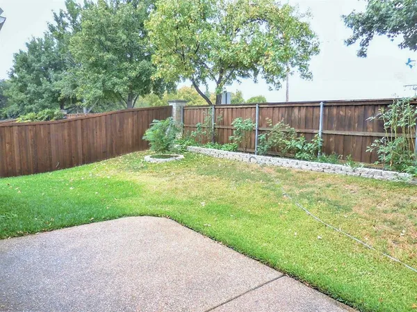 a backyard of a house with barbeque oven