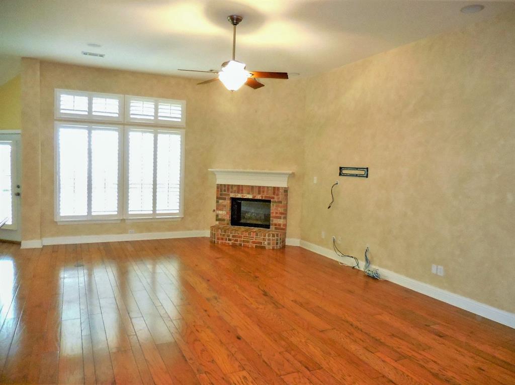 4012 Appleton Lane Flower Mound, TX 75022 - Photo 5 of 28 an empty room with wooden floor fireplace and windows