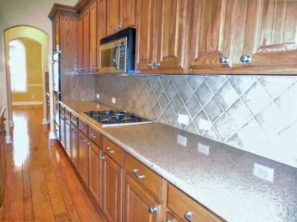 a kitchen with a sink a counter top space and cabinets