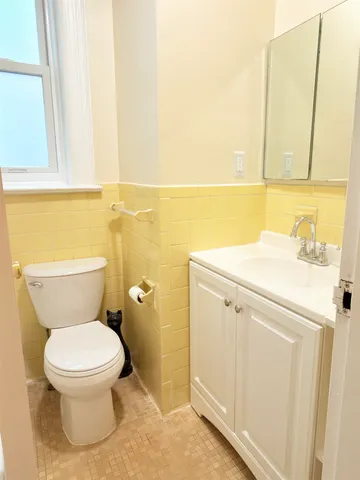 a white toilet sitting next to a bathroom sink