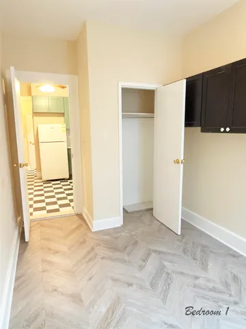 a view of a livingroom with wooden floor and cabinet