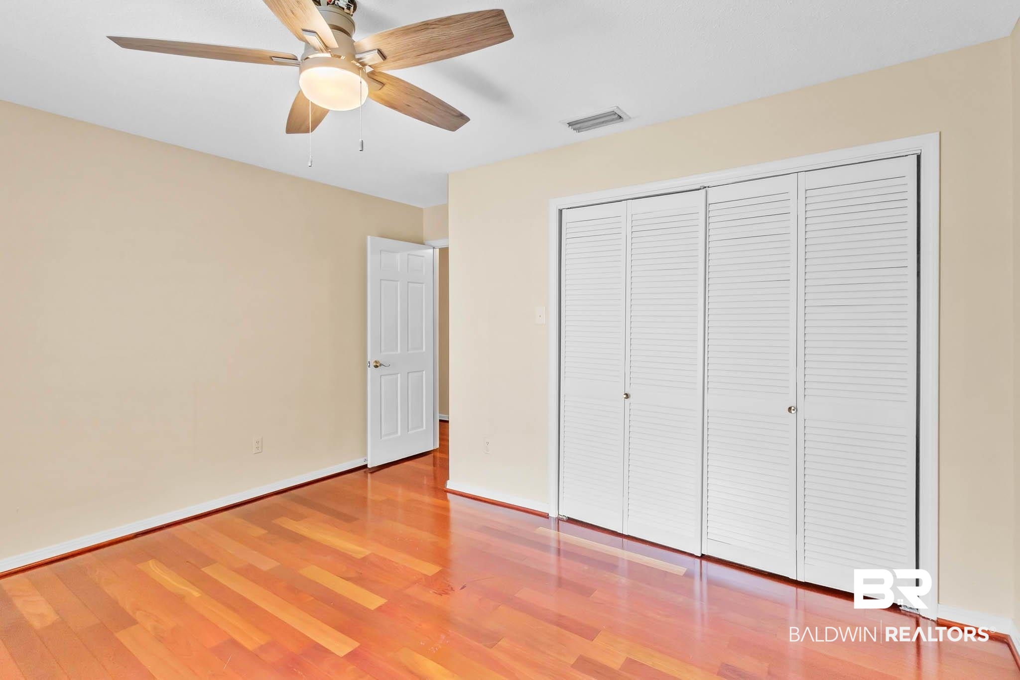 309 West Brandy Run Road Mobile, AL 36608 - Photo 55 of 100 Unfurnished bedroom featuring wood finished floors, a closet, and a ceiling fan