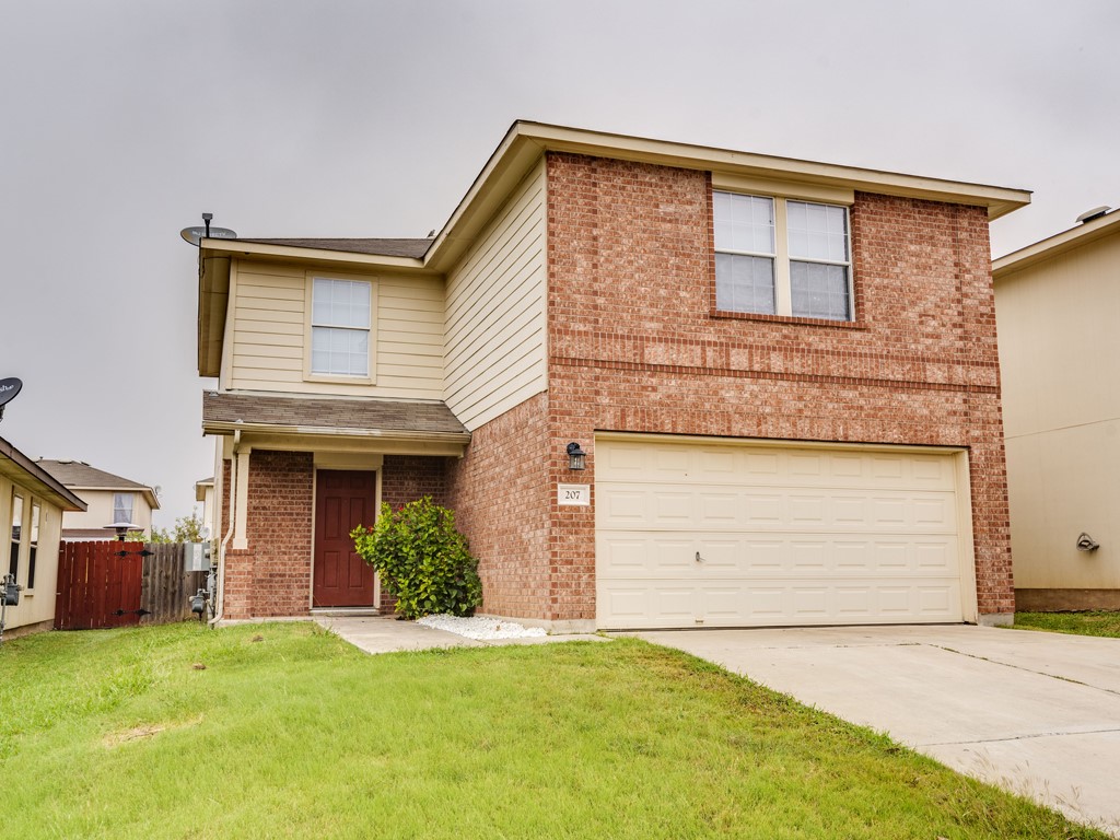 207 Black Forest Road Buda, TX 78610 - Photo 1 of 1 a front view of a house with a yard and garage