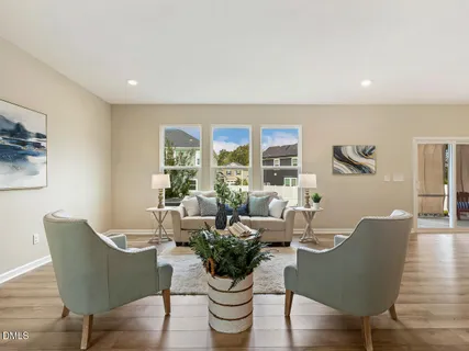a view of a dining room with furniture wooden floor and chandelier