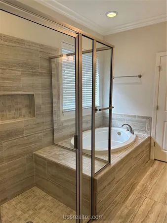 a bathroom with a tub and a shower