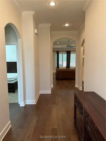 a view of a hallway to rooms and stairs