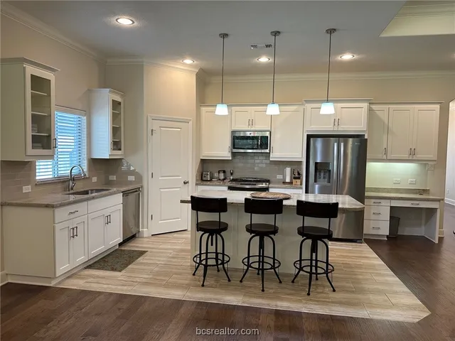 a large kitchen with a table and chairs