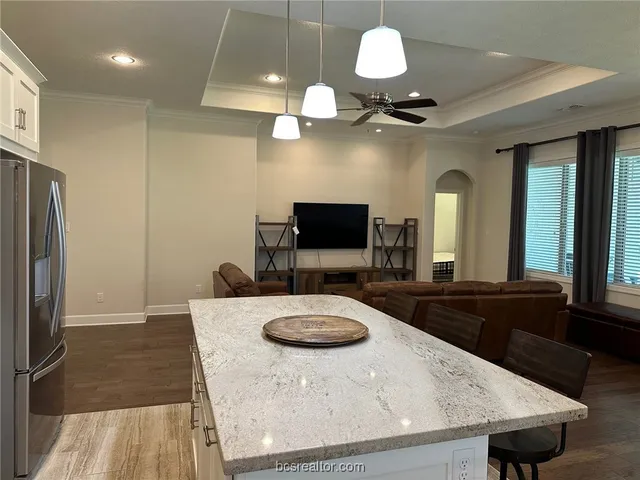 a kitchen with a table a refrigerator and a sink
