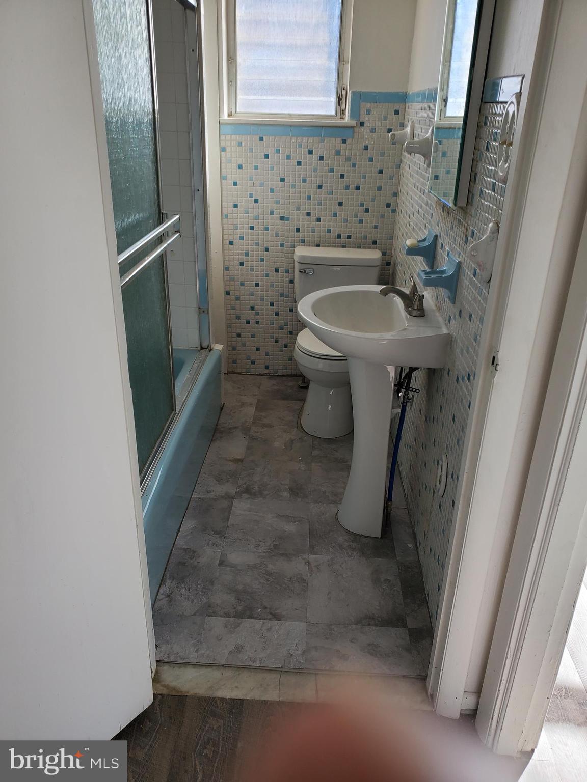 6713 Marsden Street Philadelphia, PA 19135 - Photo 11 of 13 a bathroom with a sink and toilet