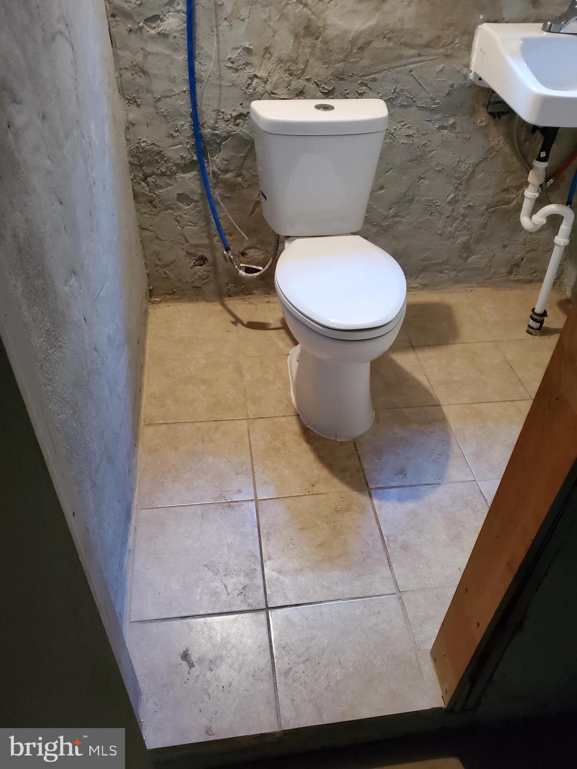 6713 Marsden Street Philadelphia, PA 19135 - Photo 12 of 13 a white toilet sitting next to a bathroom sink