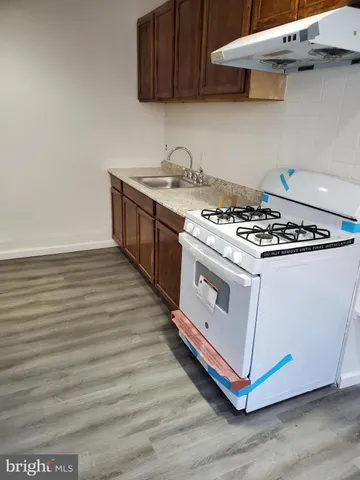 a white stove top oven sitting inside of a kitchen