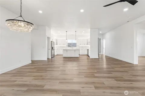 a view of a kitchen with a sink and refrigerator