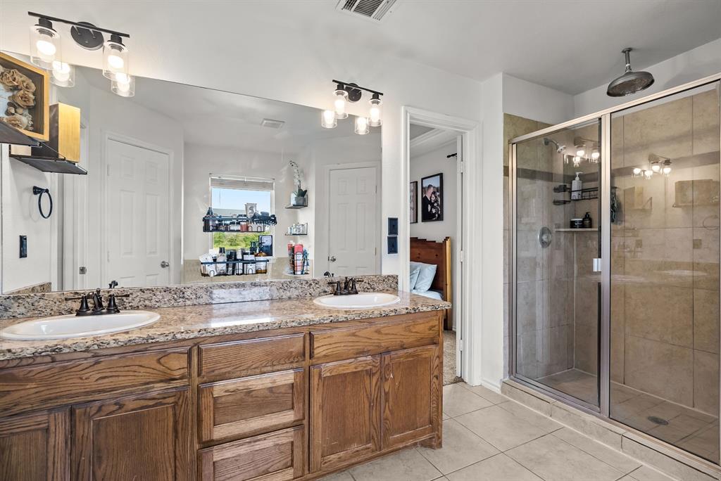 115 Blue Castle Court Weatherford, TX 76088 - Photo 14 of 33 a bathroom with a granite countertop sink mirror and shower