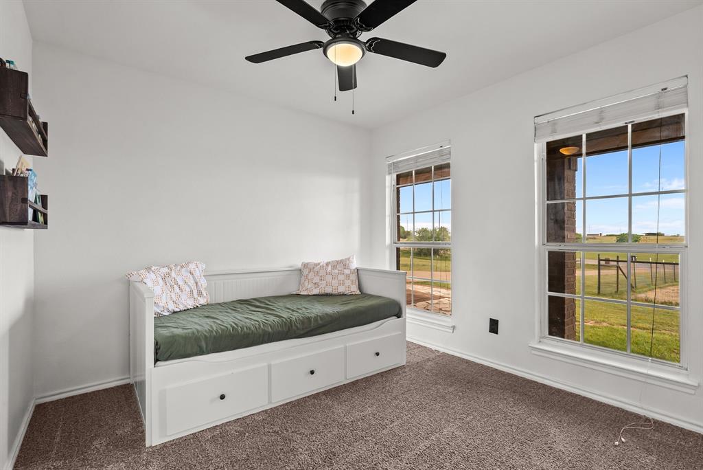 115 Blue Castle Court Weatherford, TX 76088 - Photo 18 of 33 a living room with a bed and a window