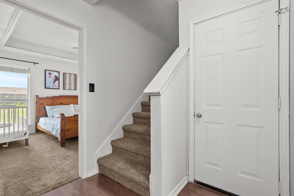 115 Blue Castle Court Weatherford, TX 76088 - Photo 22 of 33 a view of entryway bedroom and hall with wooden floor
