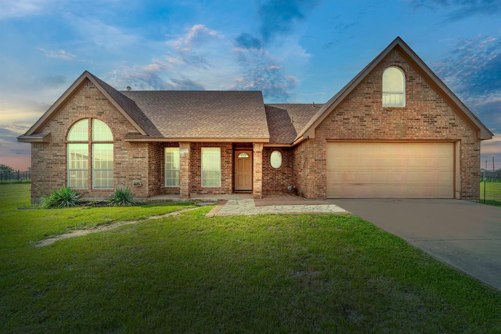 115 Blue Castle Court Weatherford, TX 76088 - Photo 32 of 33 a front view of a house with a yard and garage
