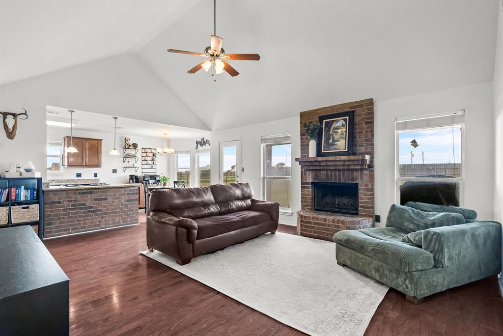 115 Blue Castle Court Weatherford, TX 76088 - Photo 6 of 33 a living room with furniture and a fireplace