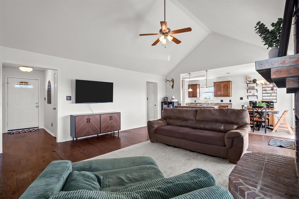 115 Blue Castle Court Weatherford, TX 76088 - Photo 7 of 33 a living room with furniture and a flat screen tv