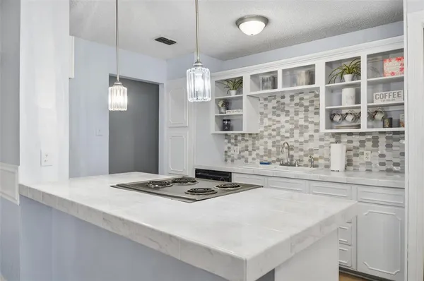 a kitchen with a sink stove and refrigerator