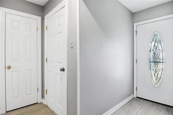 a view of front door with wooden floor